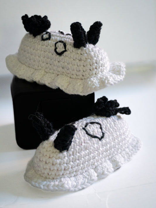 Crocheted black and white cat costume on a white background